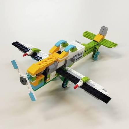 Students building a LEGO WeDo model with a laptop